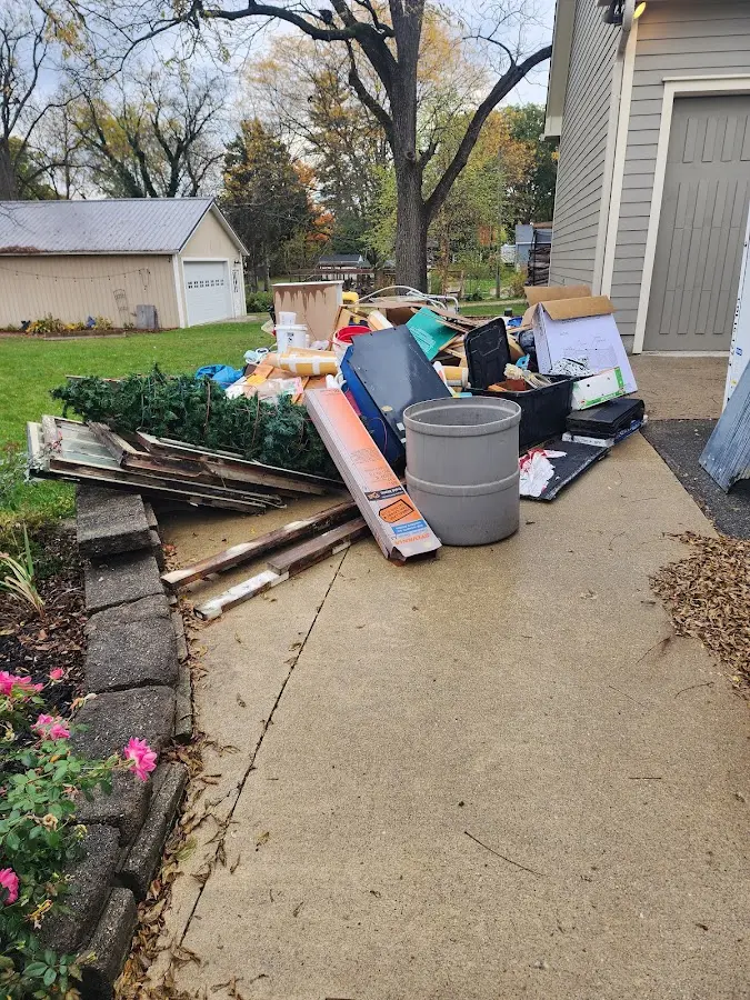 Dumpster being loaded with debris for 12 Yard Dumpster Rental in Kittanning